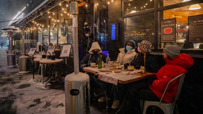 <strong>New York: </strong>Customers brave the cold while dining outside restaurants during a snowstorm in the Big Apple on December 16.