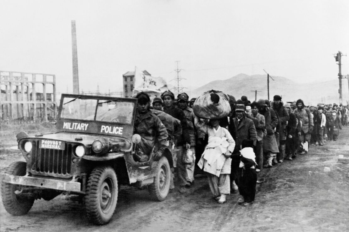 Picture released on December 26, 1950 of Korean civilians escorted by a military police jeep, fleeing to the South Korea. The picture was taken during the Korean War between North and South Korea. 