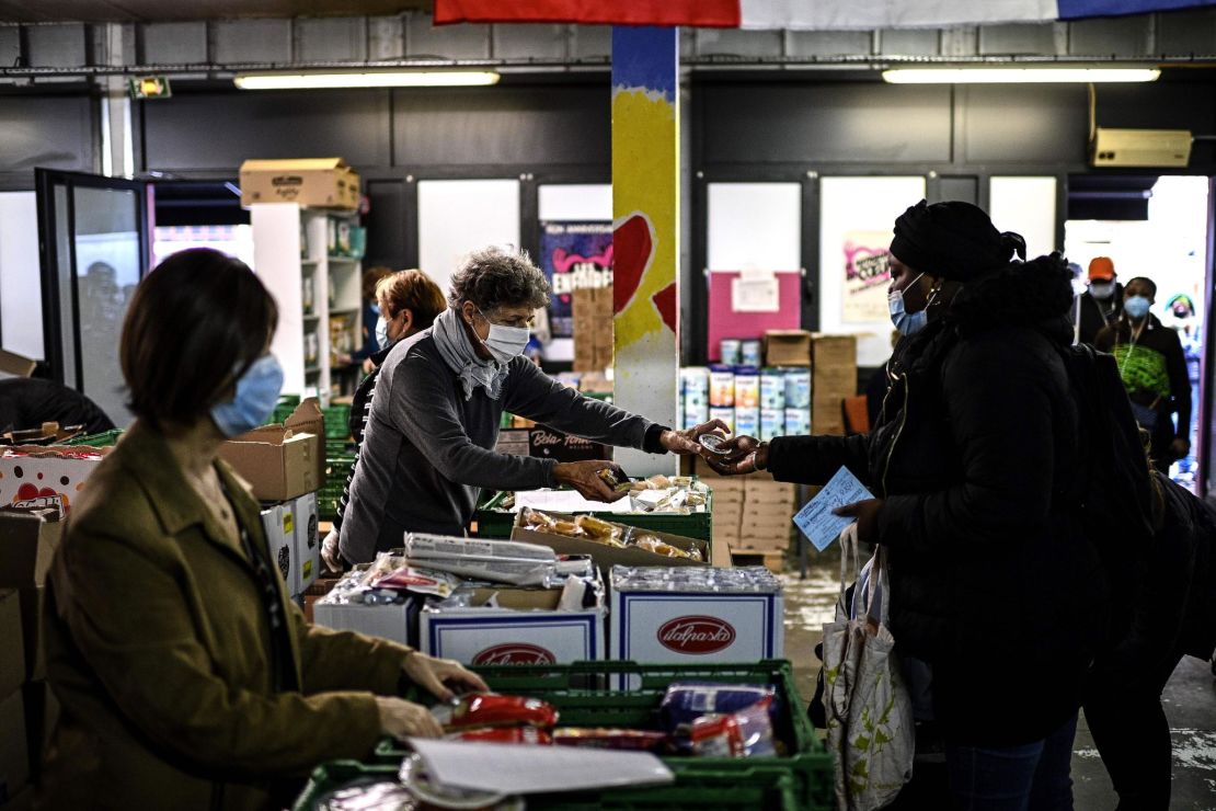 A volunteer at a Restos du Coeur center in Paris hands out food in October.