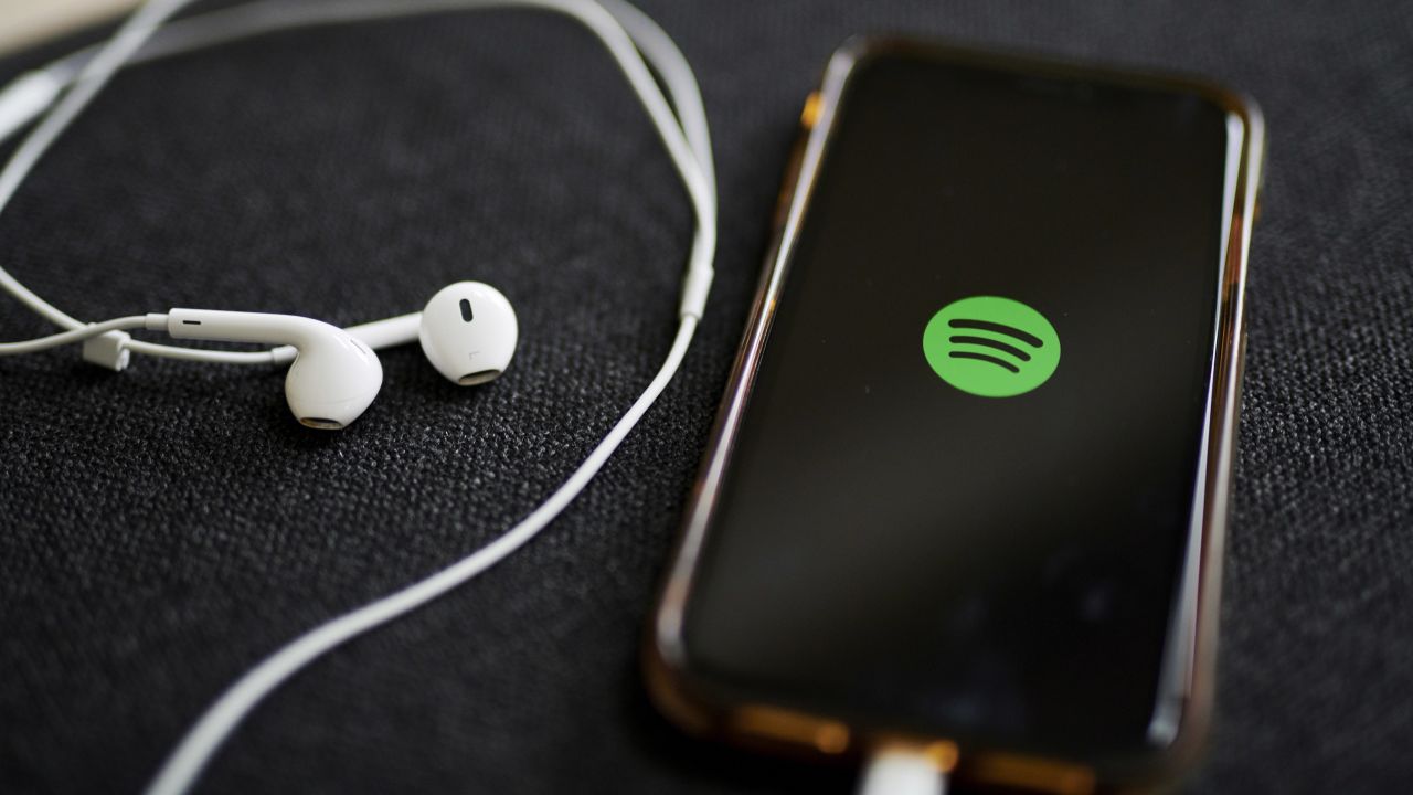 The logo for Spotify is displayed on a smartphone in an arranged photograph taken in Little Falls, New Jersey, U.S., on Wednesday, Oct. 7, 2020. Spotify has invested hundreds of millions of dollars acquiring podcast studios such as Gimlet Media and the Ringer, hoping to attract new users and advertisers to what has been a music app. Photographer: Gabby Jones/Bloomberg via Getty Images