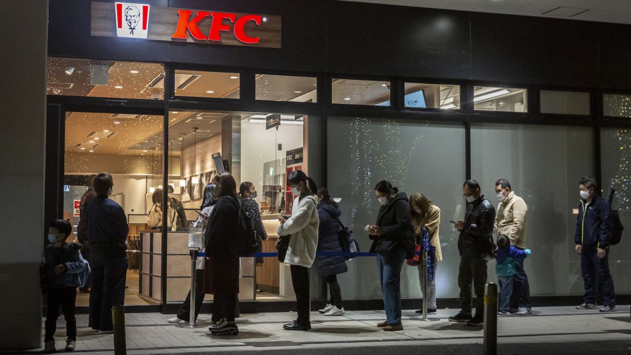 People queue in front of a KFC restaurant on December 23, 2020 in Tokyo, Japan. 