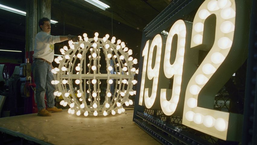 Phil Cicio, an electrician at Artkraft Strauss Sign Corporation, checks the lights on the ball that will drop in New York's Times Square on New Year's Eve, at the company's warehouse in New York, Dec. 26, 1991.  The ball weighs 200 pounds, is six feet in diameter and contains 180 white outdoor lamps.  The tradition dates back to 1907 when the first ball was lowered from the top of One Times Square, then the New York Times building.