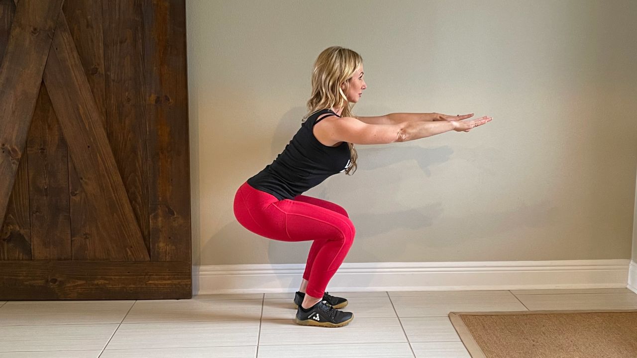 A body-weight squat strengthens the lower body.