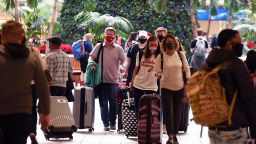 December 24, 2020 - Orlando, Florida, United States - Travelers wearing face masks arrive at Orlando International Airport on the day before Christmas, ignoring health experts who recommend against holiday travel as the coronavirus pandemic hits record levels across the United States, on December 24, 2020 in Orlando, Florida. (Photo by Paul Hennessy/NurPhoto via Getty Images)