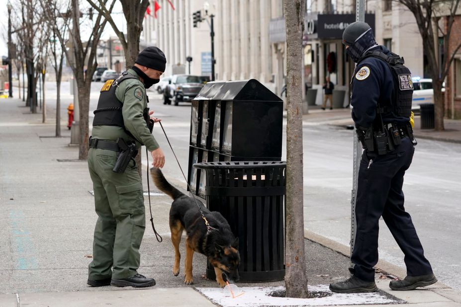 A K-9 unit works in the area of the explosion.