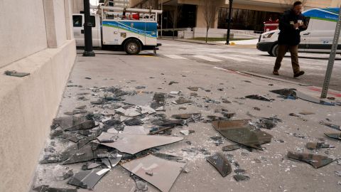 Broken window glass is scattered near the scene of an explosion on December 25.
