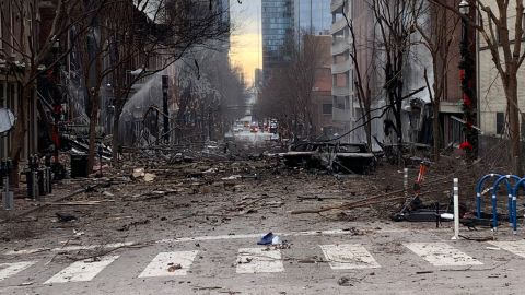 Burned cars and debris are seen on a street in downtown Nashville following an explosion.