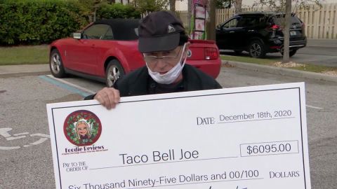 Joe DeCicco holding the check.