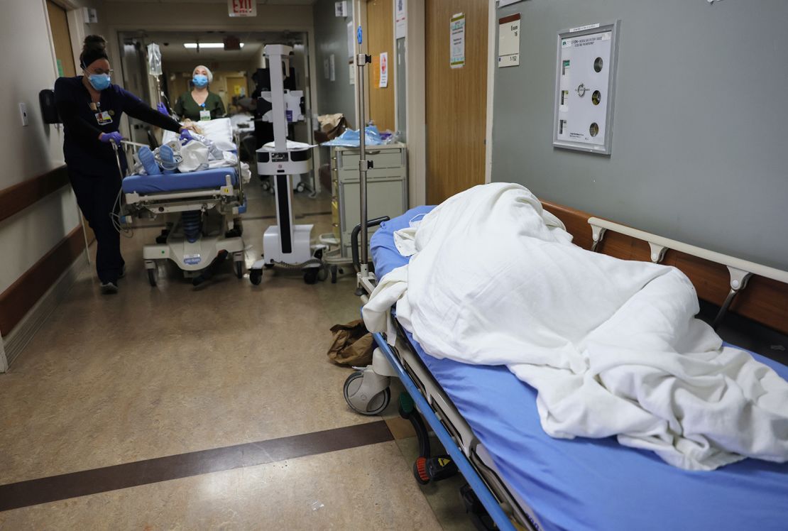 A patient lies on a stretcher in the hallway of the overloaded emergency room at Providence St. Mary Medical Center in Apple Valley, California, on December 23, 2020.
