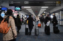 Passengers walk through a crowded terminal at Dulles International Airport in Virginia on Sunday. Holiday travel and indoor gatherings spread the coronavirus.