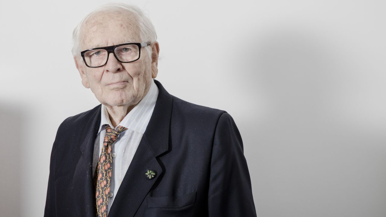 Pierre Cardin, owner and founder of Pierre Cardin, poses for a photograph following an interview in his office in Paris, France, on Monday, Dec. 19, 2016. Cardin's eponymous label has been for sale for a quarter of a century, though don't bother haggling over the price: the fashion designer who pioneered brand licensing won't entertain offers below 1 billion euros ($1.04 billion). Photographer: Marlene Awaad/Bloomberg via Getty Images