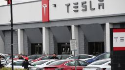 Telsa employees work outside a Tesla showroom in Burbank, California, March 24, 2020. - Luxury electric car maker Tesla ended up closing its California plant in Fremont, a concession by its maverick head Elon Musk after a drawn-out standoff with the state authorities over the spread of the virus. (Photo by Robyn Beck / AFP) (Photo by ROBYN BECK/AFP via Getty Images)