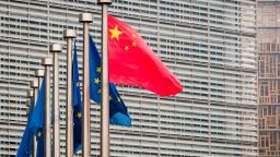 Chinas national flag, left, flies beside European Union (EU) flags ahead of the EU-China summit in Brussels, Belgium, on Tuesday, April 9, 2019. The EU and China managed to agree on a joint statement for Tuesdays summit in Brussels, papering over divisions on trade in a bid to present a common front to U.S. President Donald Trump, EU officials said. Photographer: Geert Vanden Wijngaert/Bloomberg via Getty Images
