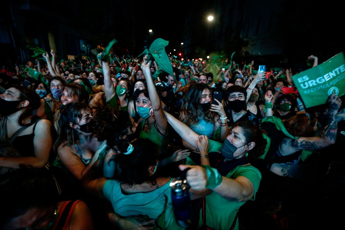Abortion rights activists celebrate after the Senate approved a bill to legalize abortion outside Congress in Buenos Aires on Wednesday morning. 