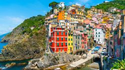 Cinque Terre, Italy - july 1st 2020 - Overview of the village Riomaggiore with a very quiet square due to Corona, one of the towns known as Cinque Terre on a sunny Corona day in summer
