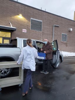 Dr. Richard Bates drove almost three hours to deliver a cooler holding 130 doses of the Covid-19 vaccine to the hospital in Alpena, Michigan.