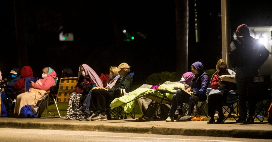 People wait in line in the early morning hours of Wednesday, December 30, 2020 at Lakes Park Regional Library in Fort Myers, Florida to recieve the COVID-19 vaccine.