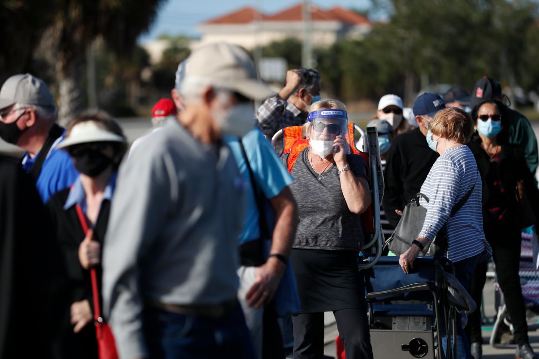 Seniors and first responders wait in line to receive a Covid-19 vaccine at the Lakes Regional Library on December 30, 2020, in Fort Myers, Florida.