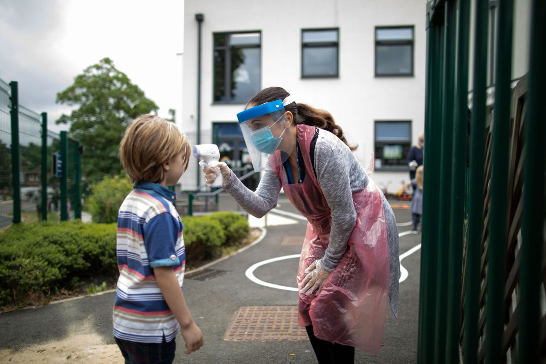 A school staff member takes a child's temperature at the Harris Academy's Shortlands school in London on June 4.