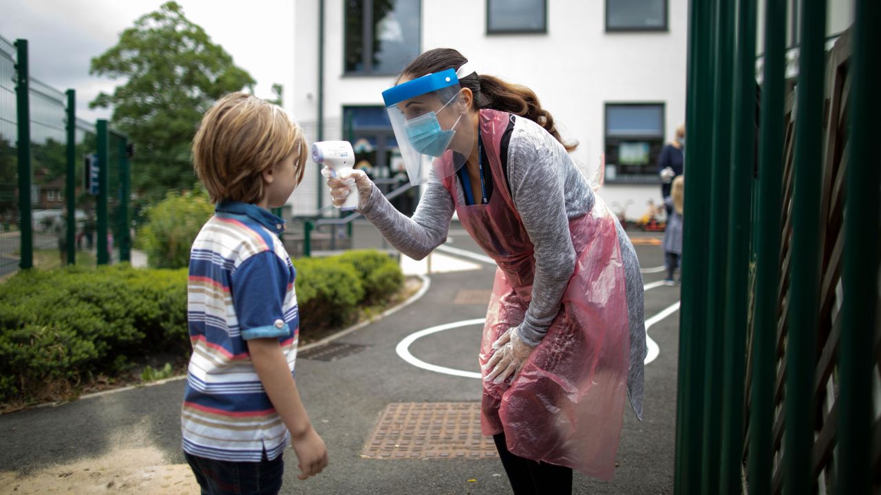 A school staff member takes a child's temperature at the Harris Academy's Shortlands school in London on June 4.