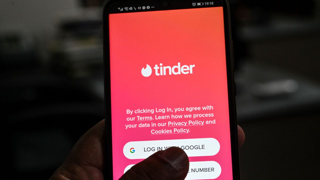 A user checks the dating app Tinder on a mobile phone.