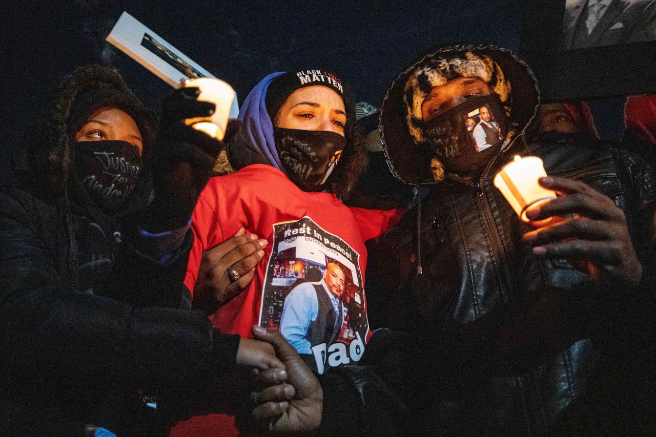 Karissa Hill, center, is comforted by loved ones at a candlelight vigil honoring her father's memory on Saturday, December 26. Andre Hill, 47, <a href="https://www.cnn.com/2020/12/31/us/andre-hill-shooting-columbus-mayor/index.html" target="_blank">was fatally shot by a police officer</a> in Columbus, Ohio, on December 22.