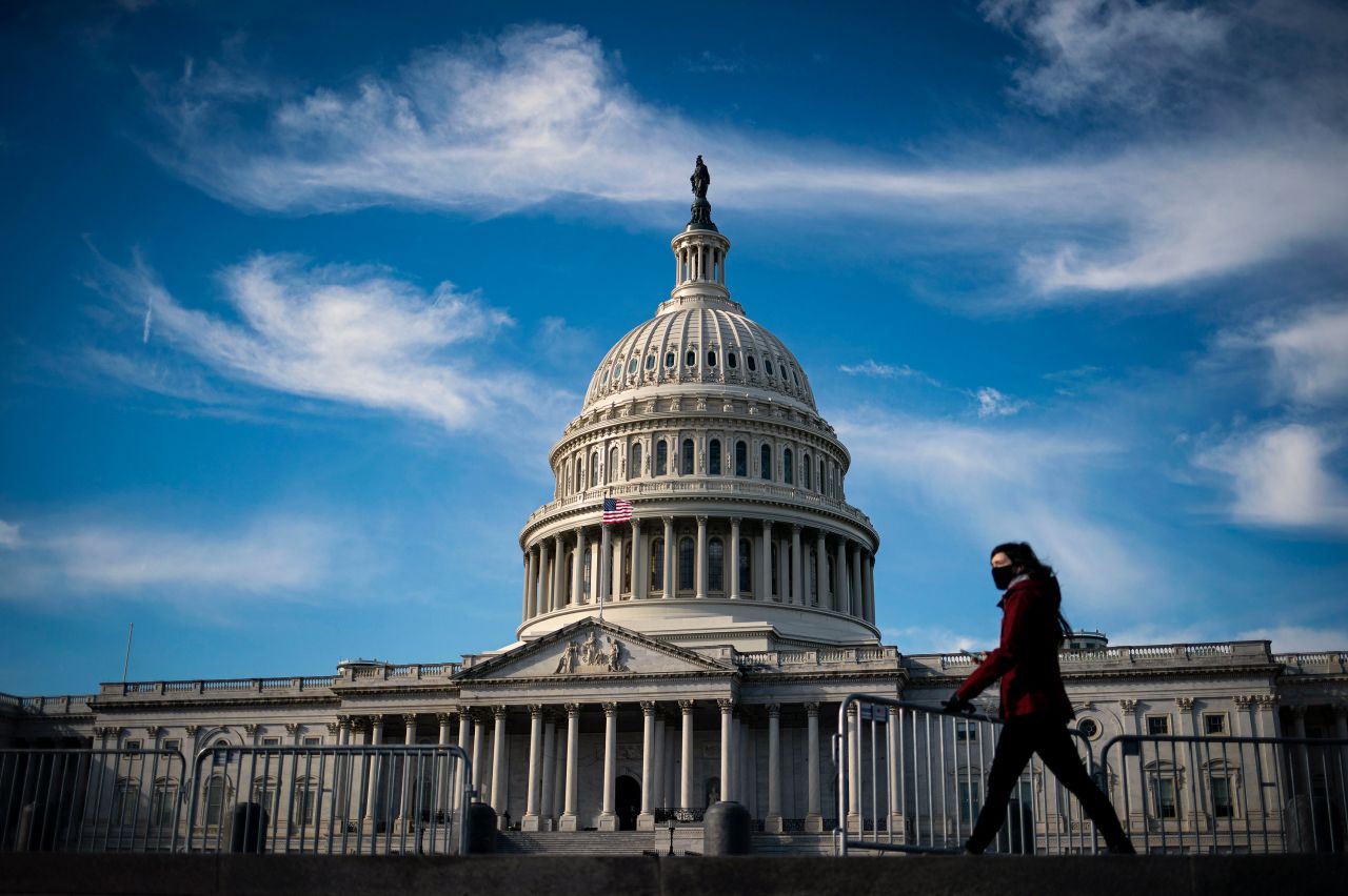 A person walks near the US Capitol on Wednesday, December 30. President Donald Trump <a href="https://www.cnn.com/2020/12/27/politics/trump-relief-bill-christmas-eve/index.html" target="_blank">signed a $2.3 trillion coronavirus relief and government funding bill</a> on December 27, averting a government shutdown that was set to begin. The legislation includes direct cash payments and enhanced unemployment benefits.