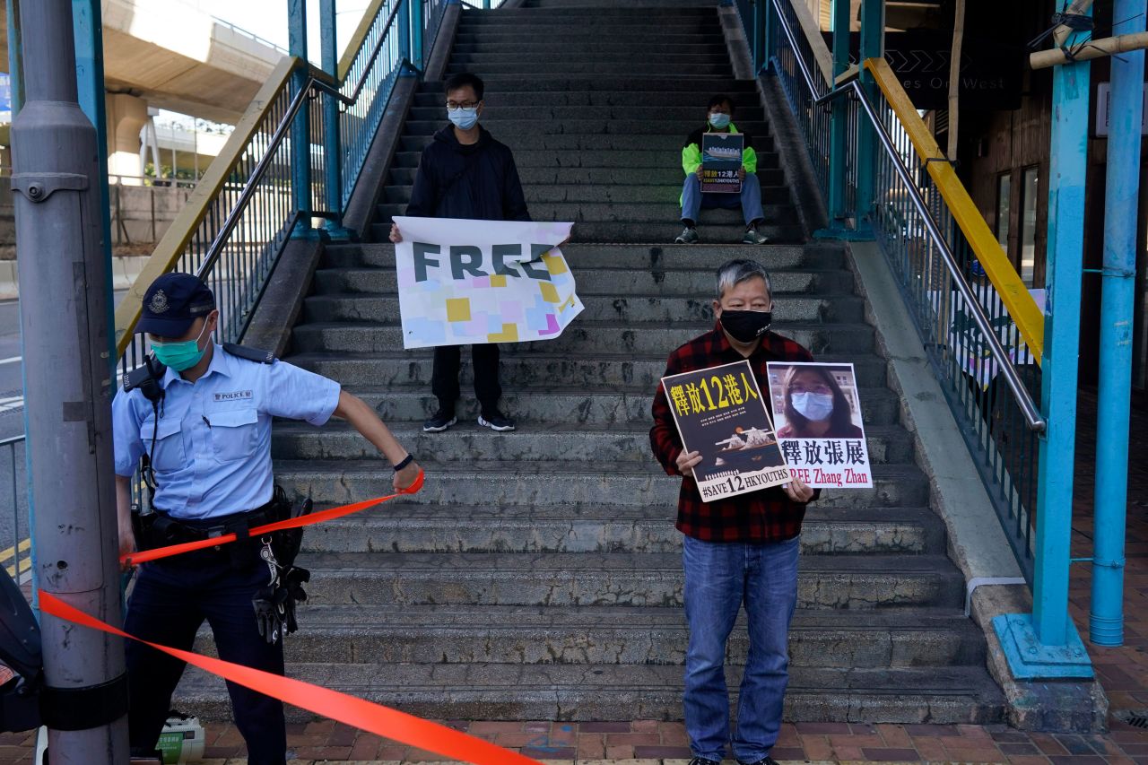 Pro-democracy activists hold placards that show Chinese journalist Zhang Zhan as they march to the Chinese central government's liaison office in Hong Kong on Monday, December 28. Zhang, an independent journalist who reported from Wuhan, China, at the height of the initial coronavirus outbreak, <a href="https://www.cnn.com/2020/12/28/asia/china-journalist-zhang-zhan-intl-hnk/index.html" target="_blank">has been jailed for four years by a Shanghai court.</a> She was found guilty of "picking quarrels and provoking trouble," according to one of her defense lawyers who attended her hearing. The offense is commonly used by the Chinese government to target dissidents and human-rights activists. Zhang is the first citizen journalist known to have been sentenced for her role in reporting on the coronavirus pandemic. She is one of a number of independent reporters who have been detained or disappeared in China since the beginning of the pandemic.