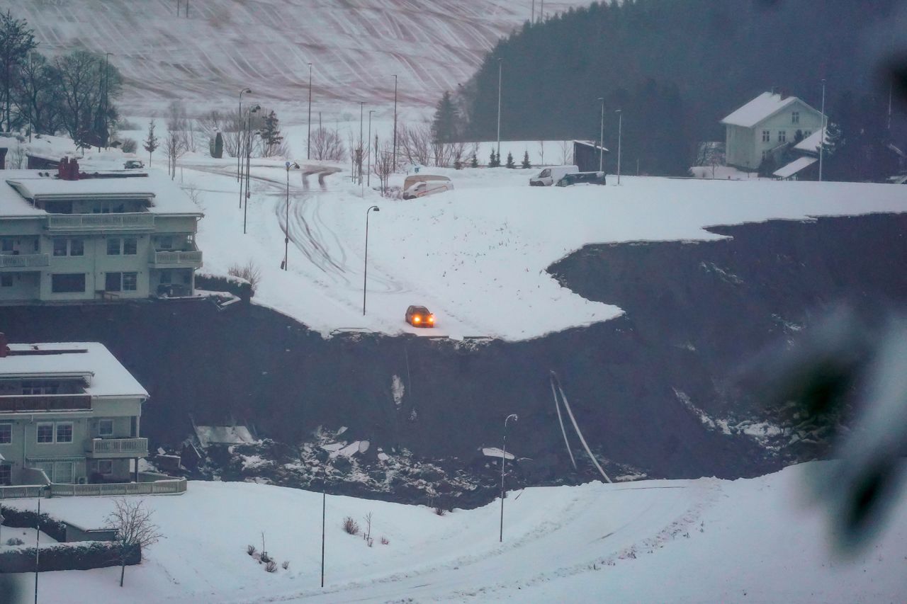 A car stops where the road was swept away by a landslide in Ask, Norway, on Wednesday, December 30. Ten people were injured, one of them critically, and 11 were classified as missing after <a href="https://www.cnn.com/2020/12/31/europe/norway-landslide-intl-hnk-scli/index.html" target="_blank">the landslide</a> swept away more than a dozen buildings, police said.