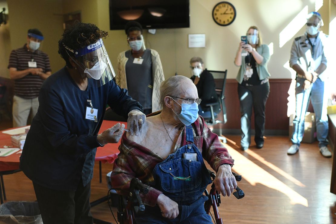 A nurse administers the Covid-19 vaccine to Korean War veteran Melvin Menard, 88, in Aurora, Colorado, on December 22.