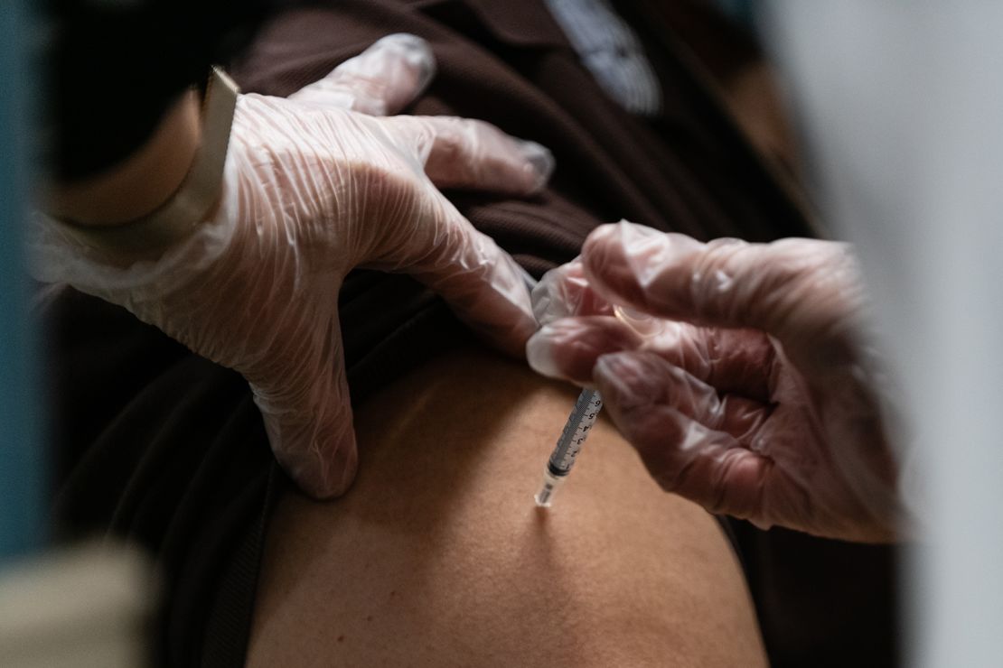 A pharmacist administers a dose of the Pfizer-BioNTech Covid-19 vaccine to a nursing home resident in the Bronx borough of New York on December 21, 2020.