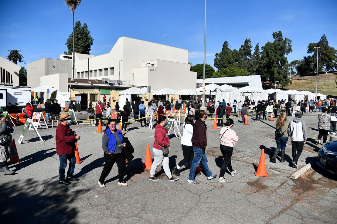 People wait in line at a coronavirus testing and vaccination site on December 30, 2020 in Los Angeles, California. 