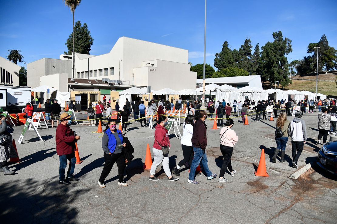People wait in line at a coronavirus testing and vaccination site on December 30, 2020 in Los Angeles, California.