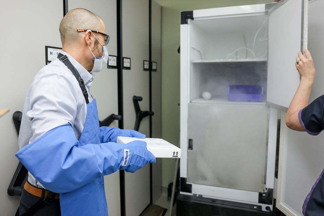A pharmacist moves 975 doses of the Pfizer-BioNTech Covid-19 vaccine to a freezer on December 15, 2020 in Aurora, Colorado.