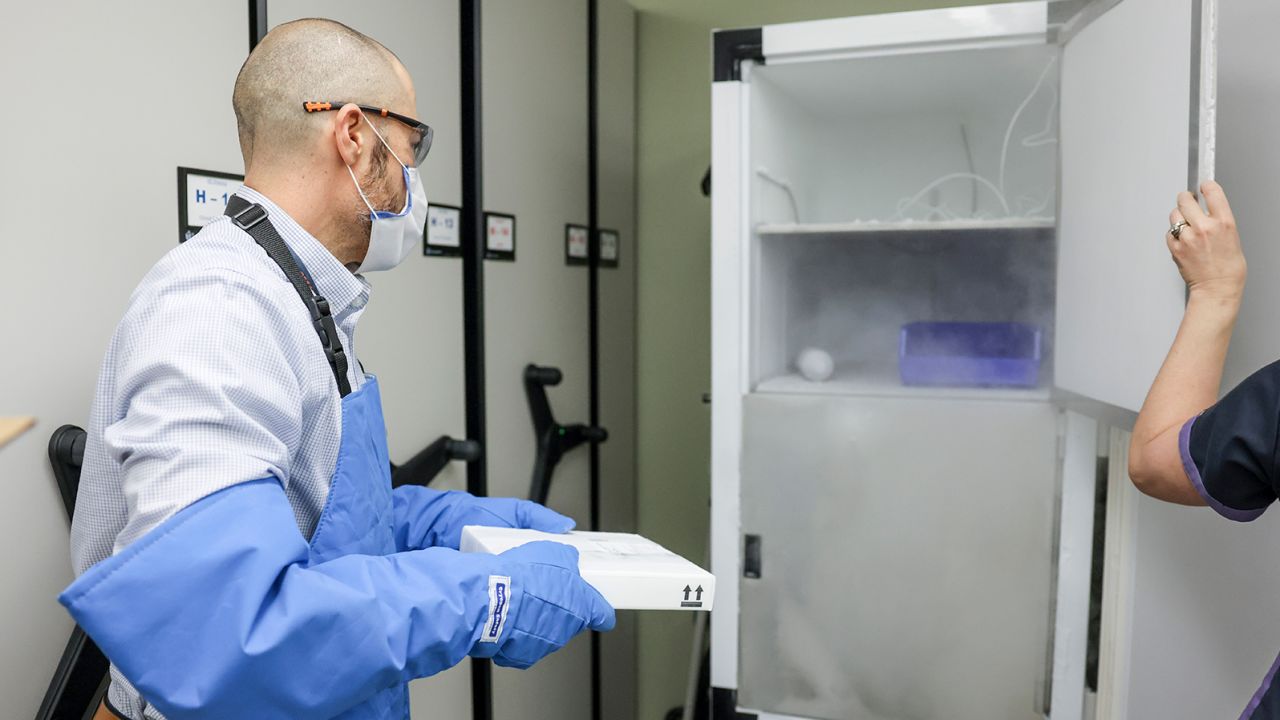A pharmacist moves 975 doses of the Pfizer-BioNTech Covid-19 vaccine to a freezer on December 15, 2020 in Aurora, Colorado. 