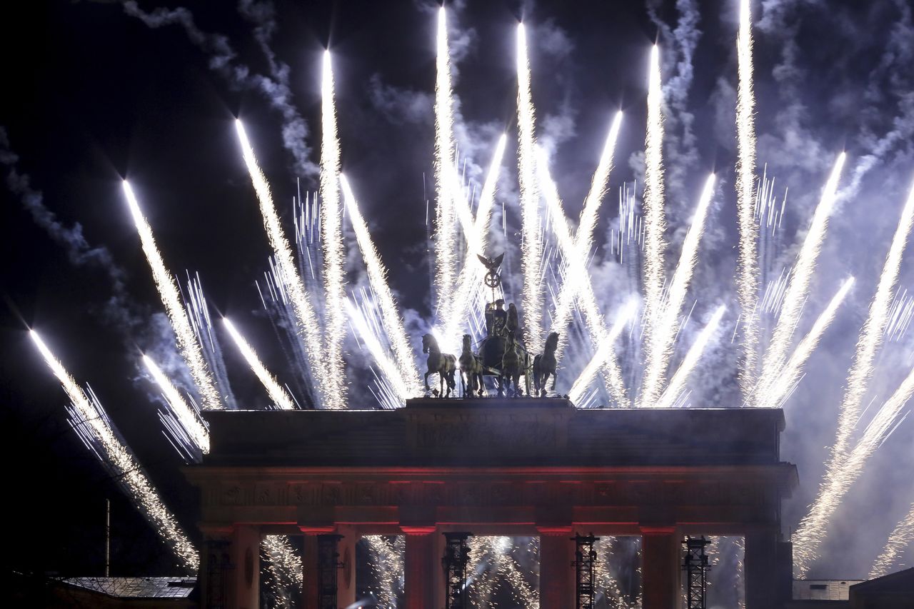 Fireworks light the sky behind the Brandenburg Gate in Berlin.