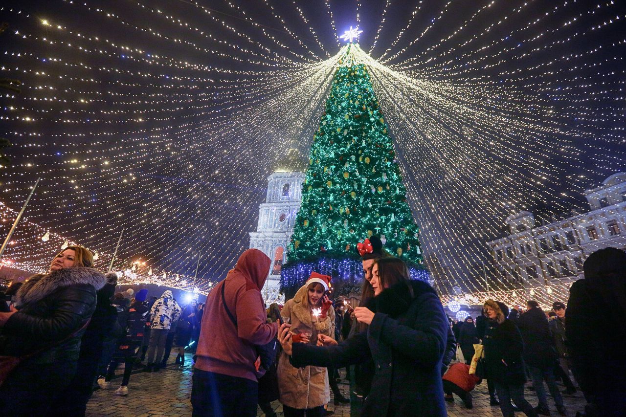 People celebrate under the lights of a Christmas tree in Kiev, Ukraine.