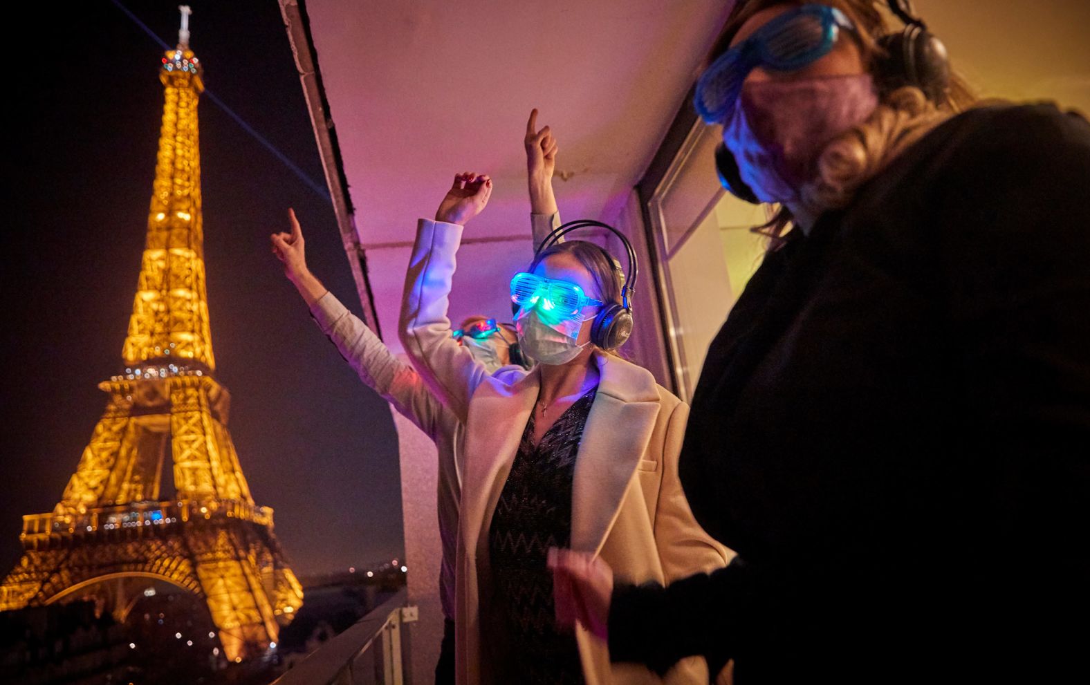 Hotel guests in Paris welcome 2021 near the Eiffel Tower. New Year's Eve fireworks were canceled throughout France, and an 8 p.m. curfew was imposed to prevent the spread of Covid-19.