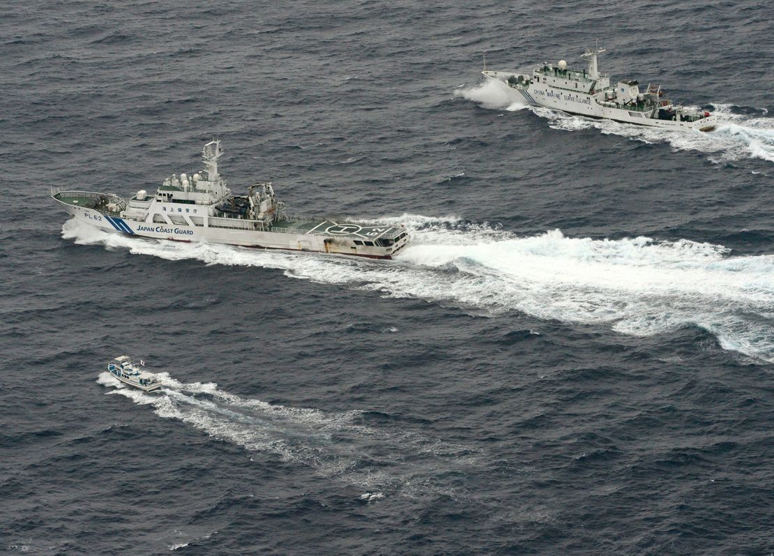 An aerial photo shows Chinese marine surveillance ship Haijian No. 66 (top) trying to approach a Japanese fishing boat (bottom) as Japan Coast Guard vessel Ishigaki cruises next to the Chinese ship, in the East China Sea, near what are known as the Senkaku isles in Japan and the Diaoyu islands in China, in this photo taken on April 23, 2013.