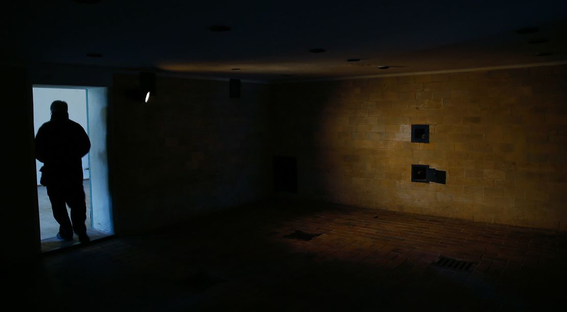 A visitor stands in 2014 at the entrance to a gas chamber in the former concentration camp in Dachau near Munich.
