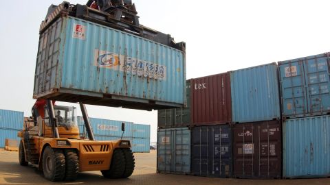 A forklift transfers a shipping container for export at a port in Lianyungang, Jiangsu province May 5, 2014. China's overall trade is likely to gain momentum after May when high base effects fade off and data more accurately reflects the underlying picture, the commerce ministry said in a report on its website. Picture taken May 5, 2014. REUTERS/China Daily (CHINA - Tags: BUSINESS POLITICS) CHINA OUT. NO COMMERCIAL OR EDITORIAL SALES IN CHINA