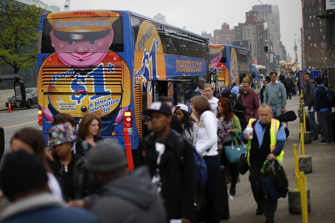 Passengers line up to board Megabus buses in New York City in 2014. Curbside carries have drawn new riders but do not usually have facilities.