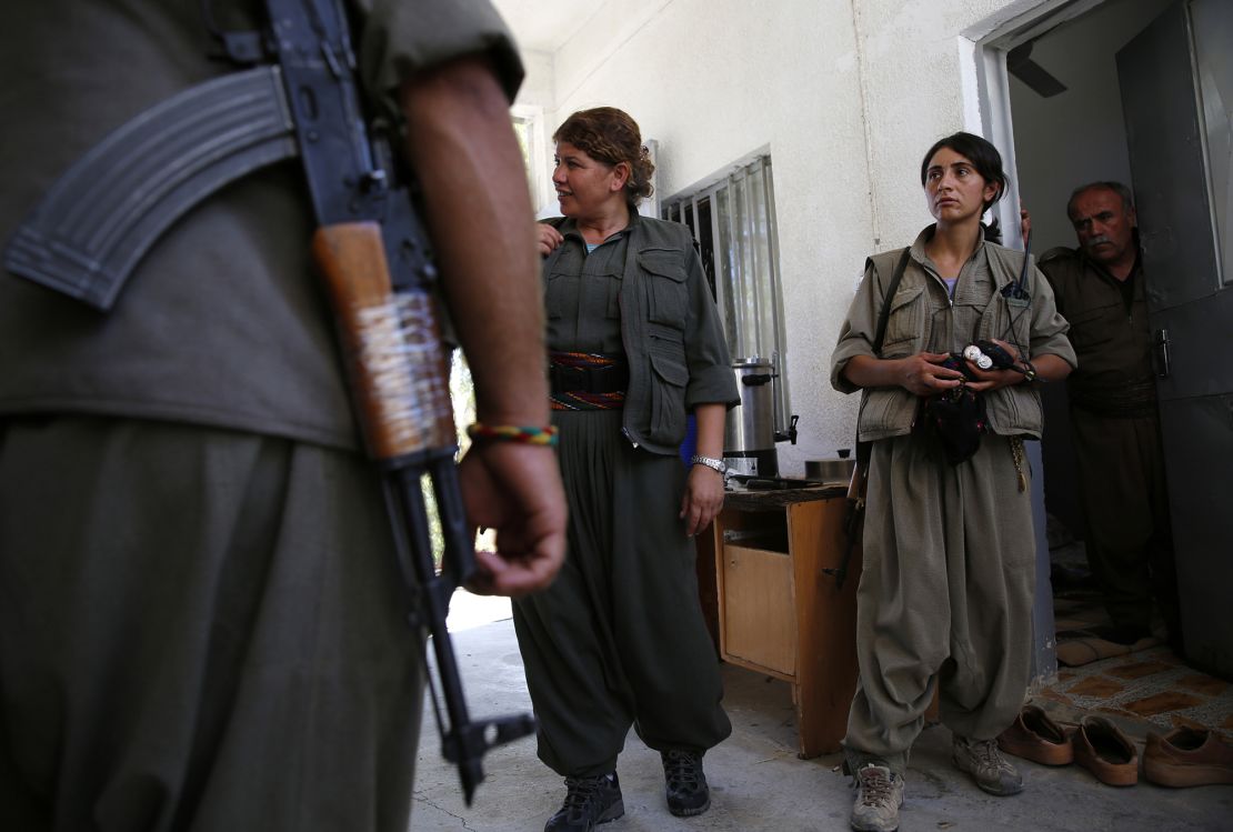 Female members of PKK walk at their camp, near the frontline of the fight against ISIS militants in Makhmur, south of Erbil, on September 13, 2014.