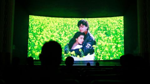Bollywood actors Shah Rukh Khan (R) and Kajol (L) are seen on the screen during the screening of "Dilwale Dulhania Le Jayenge" (The Big Hearted Will Take the Bride) inside Maratha Mandir theatre in Mumbai December 11, 2014. The movie, released in October 1995, has set a record of completing 1000 weeks of continuous screening at a cinema, a feat unmatched by any other Bollywood movies. According to Manoj Desai, owner of the theatre, the movie, which is still being screened, enjoys at least 50 to 60 percent occupancy on weekdays and full house on weekends at his theatre. The movie is screened only in the morning and the ticket price ranges from 15 to 20 Indian rupees ($0.24-$0.32). Picture taken December 11, 2014.  REUTERS/Danish Siddiqui (INDIA - Tags: ENTERTAINMENT SOCIETY)