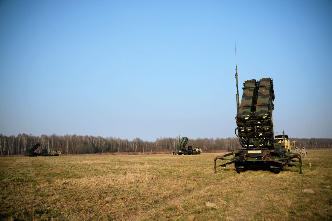 US soldiers walk next to a Patriot missile defense battery during joint exercises at the military grounds in Sochaczew, Poland on March 21, 2015.