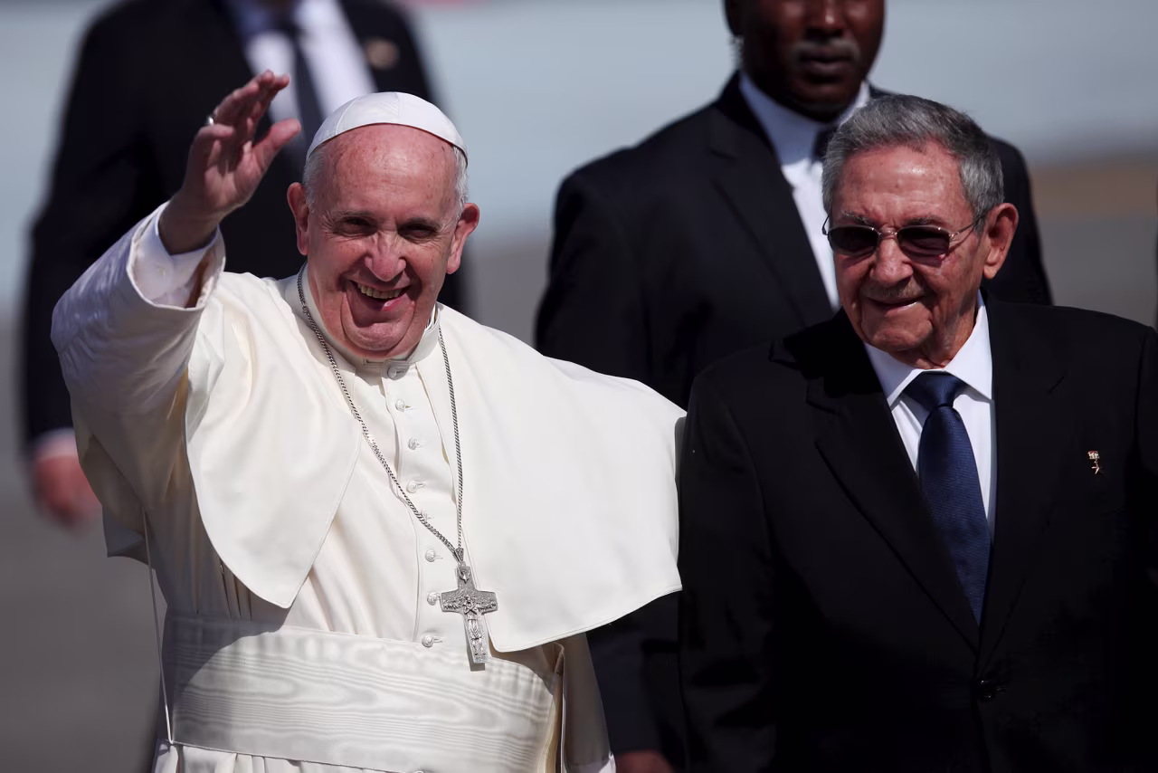 Pope Francis waves to journalists as he walks beside Cuba's President Raul Castro after his arrival at the Jose Marti International Airport in Havana in February 2016.