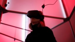 A woman plays a video game with the Oculus Rift VR headset at the mk2 VR, a place dedicated to virtual reality in Paris, France, December 5, 2016.