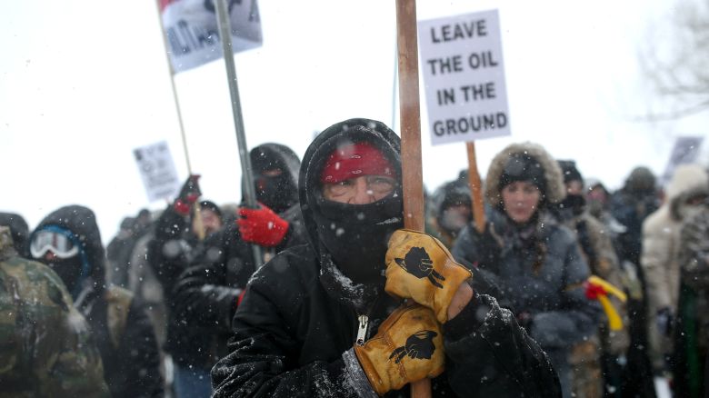 A Native American man leads a protest march with veterans and activists outside the Oceti Sakowin camp where "water protectors" continue to demonstrate against plans to pass the Dakota Access pipeline adjacent to the Standing Rock Indian Reservation, near Cannon Ball, North Dakota, U.S., December 5, 2016.  Picture taken December 5, 2016.   REUTERS/Stephen Yang