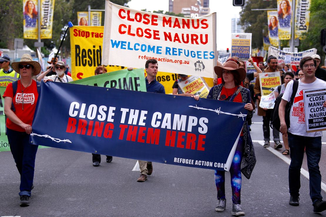 In 2017, refugee advocates hold placards as they protest in central Sydney, Australia, against the treatment of asylum seekers in detention centers in Nauru and on Manus Island.