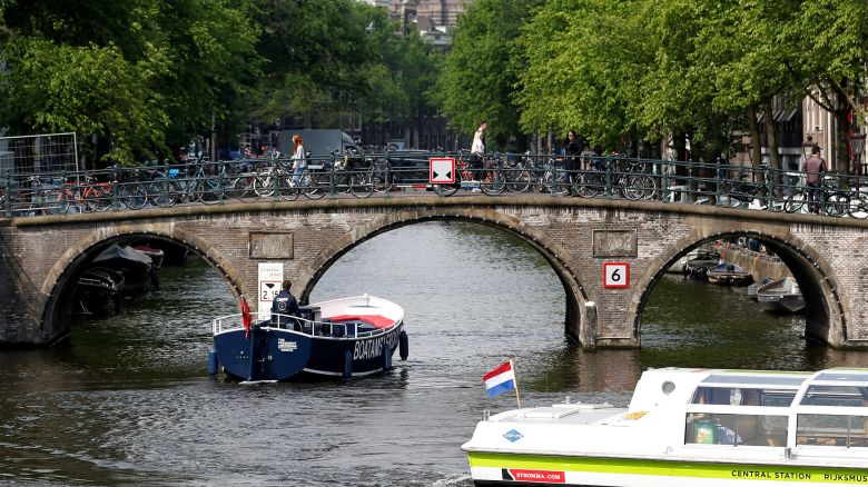 Tourists boats pass on a canal in Amsterdam, Netherlands, May 16, 2018. REUTERS/Francois Lenoir